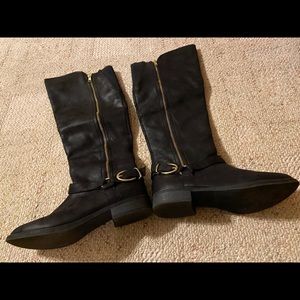 Black riding boots with gold buckle..